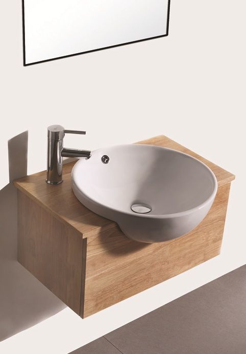 a white sink sitting on top of a wooden counter next to a wall mounted mirror