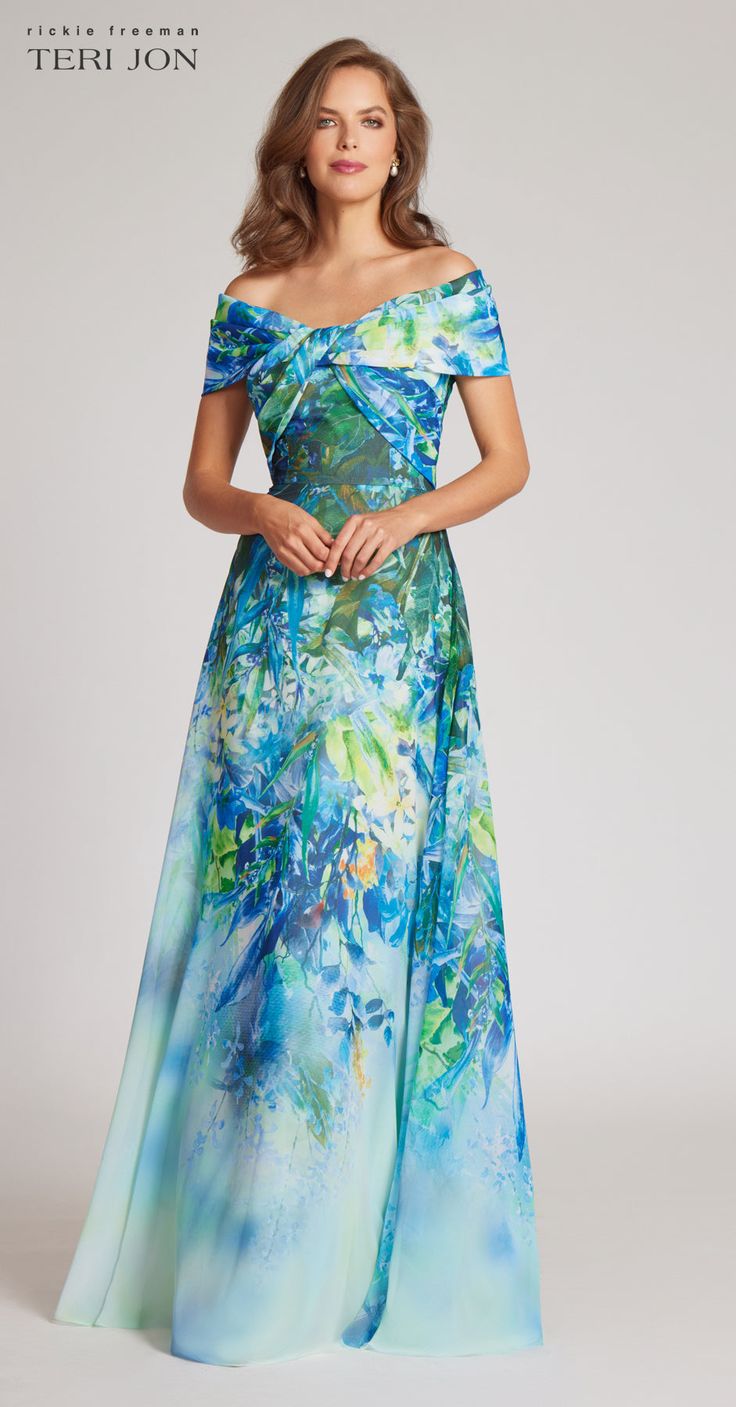 Step into sophistication with this colorful off the shoulder evening dress! This enhancing ensemble features a mesmerizing blue leaf print, an alluring off shoulder neckline with delicate crisscross detailing, a defined waist for a flattering silhouette, and a gracefully flowy skirt in ethereal chiffon. Wear this stunning piece to a destination wedding or formal spring affair. Pair with gold accessories to complete the look. Color: Blue Multi Off the shoulder neckline Crisscross bodice Defined w Off Shoulder Evening Dress, Quince Dress, Teri Jon, Summer 2025, Printed Gowns, Groom Dresses, Floral Print Chiffon, Summer Fashion Dresses, Chiffon Gown