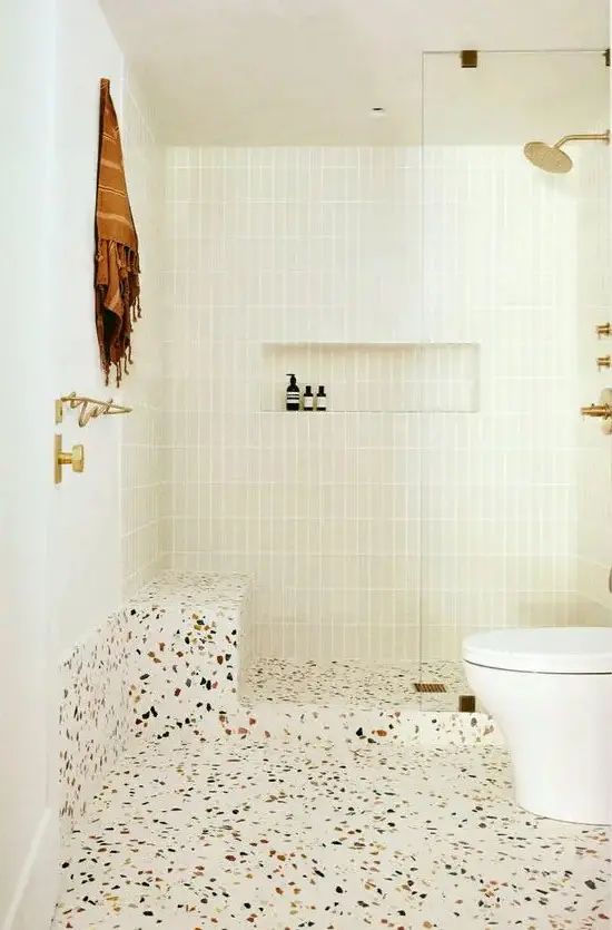 a white toilet sitting next to a walk in shower