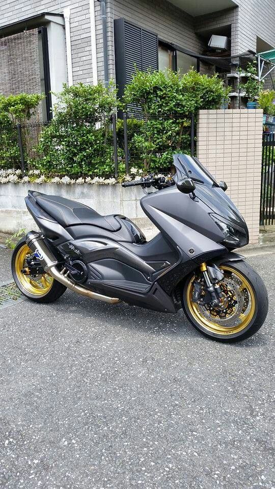 a black and gold motorcycle parked in front of a building