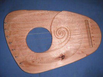 a wooden instrument that is sitting on a blue surface