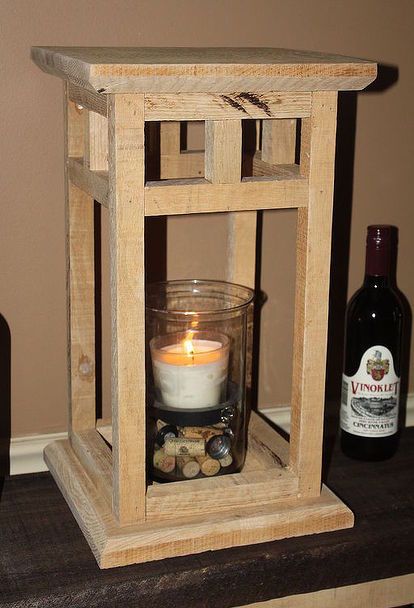 a candle is lit in a wooden lantern