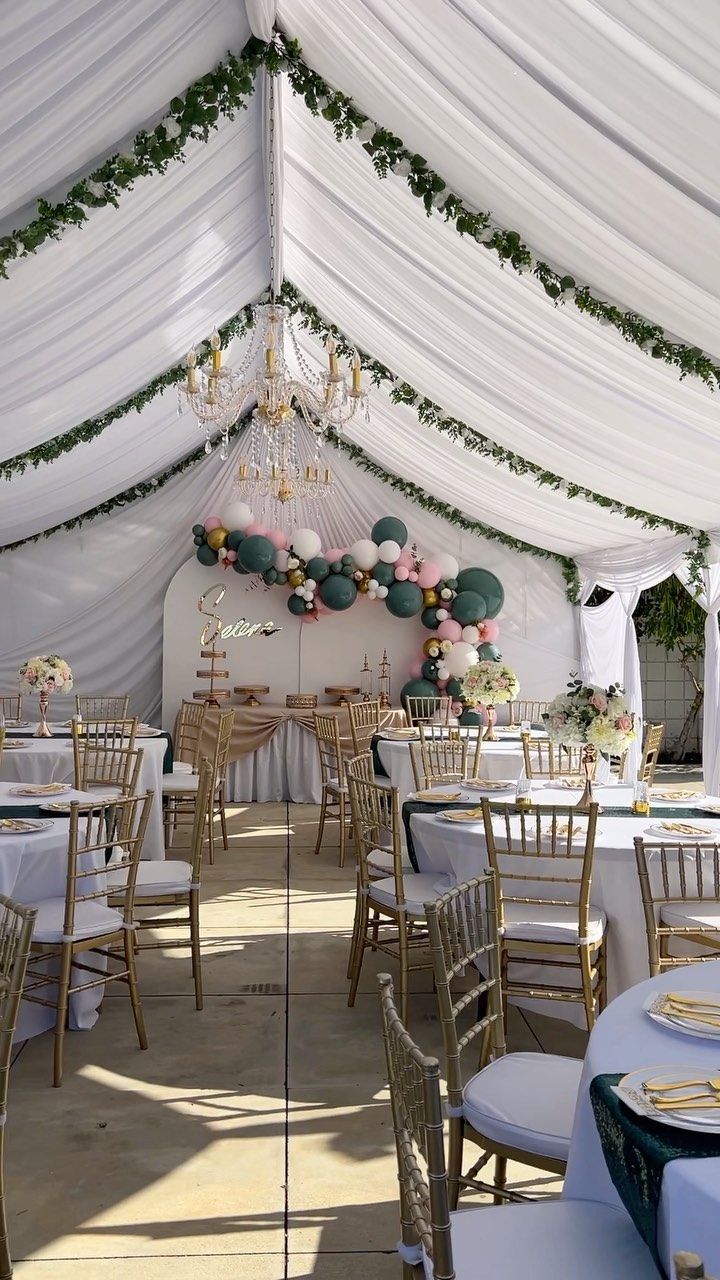 the inside of a tent with tables and chairs set up for a wedding or party