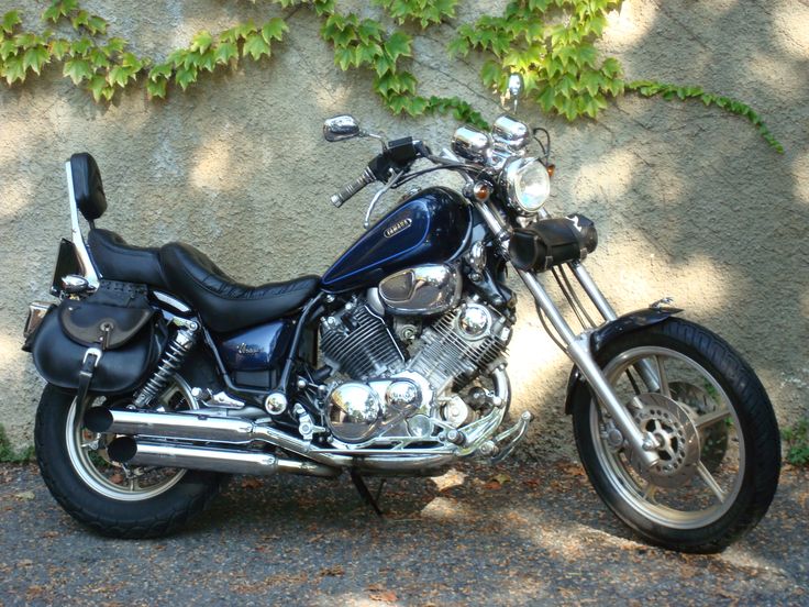 a blue motorcycle parked in front of a wall