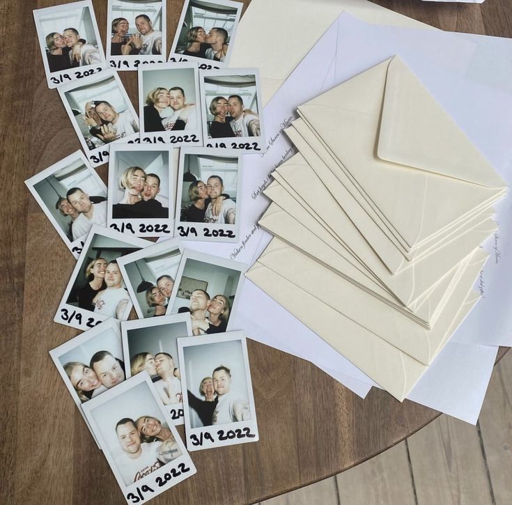 a table topped with lots of photos and envelopes