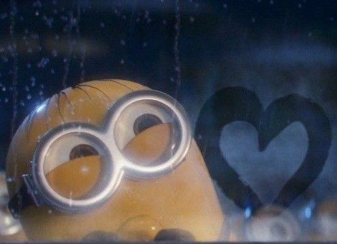 a close up of a minion behind a window