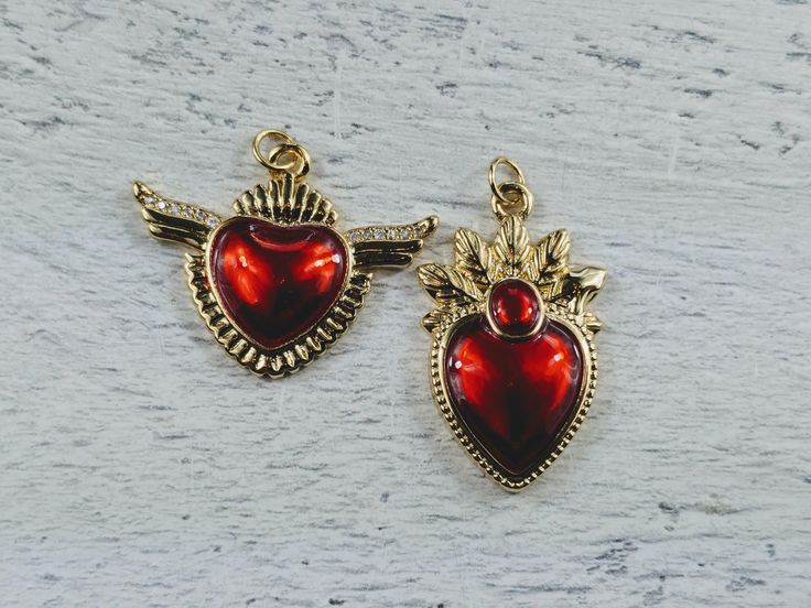 Love these new charms 18k gold plating over brass red epoxy heart cz crystals in the wing heart  jump ring at top  listing is for 1 charm lead and cadmium free measurements: left charm: 45x31mm  right charm: 31x20mm Heart Cut Enamel Jewelry For Gifts, Heart-shaped Metal Charms For Gifts, Metal Charms For Valentine's Day Gift, Valentine's Day Metal Charms For Gifts, Red Enamel Jewelry For Valentine's Day, Metal Heart Charm For Valentine's Day, Valentine's Day Metal Heart Charm, Nickel-free Pendant Charms For Valentine's Day, Double Heart Enamel Jewelry For Gifts