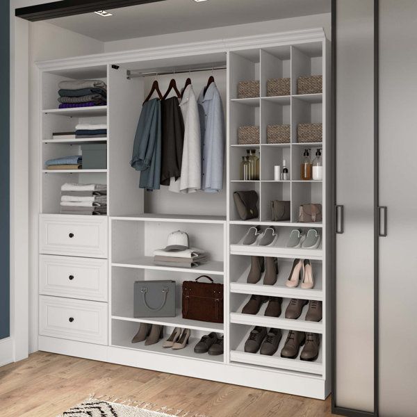 a white closet with shoes and bags on it, next to a rug in the floor