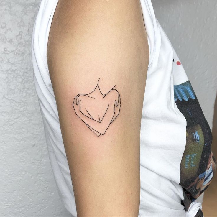 a woman's arm with a tattoo on it that is shaped like a heart