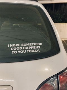 a car that has some stickers on the side of it with words written in white