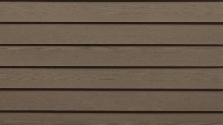 the side of a house with brown siding