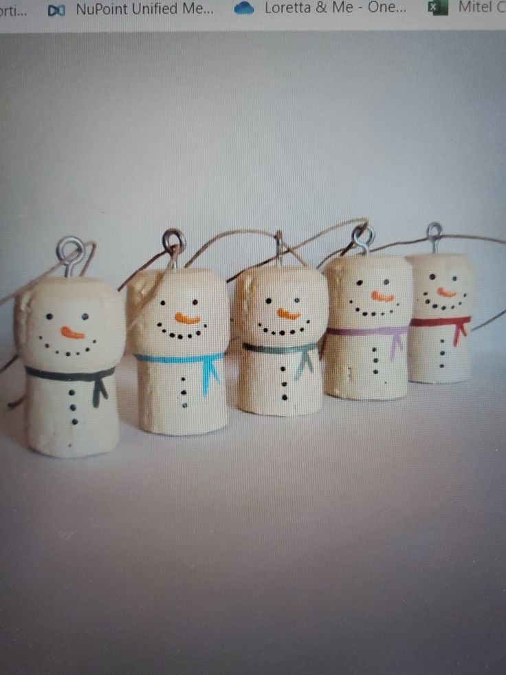 four snowmen are hanging from the side of a computer screen