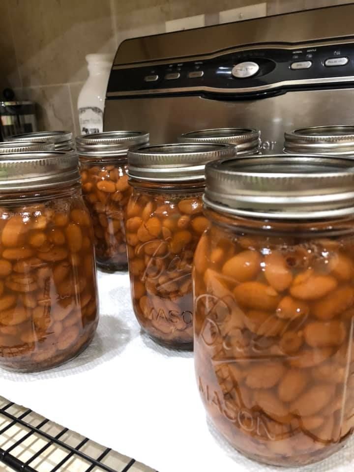 several jars filled with beans sitting on top of a counter next to an oven door