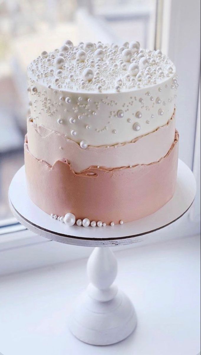 a cake sitting on top of a white plate next to a window sill with the words instagram above it