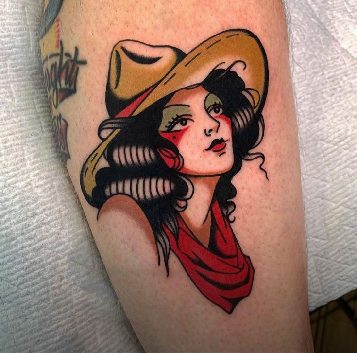 a woman with a cowboy hat and scarf on her arm is depicted in this tattoo design