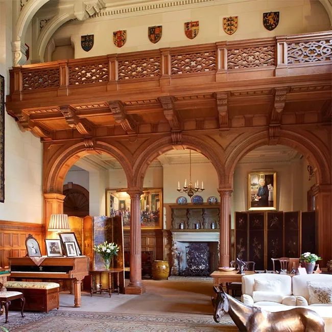 an ornately decorated living room with couches and tables