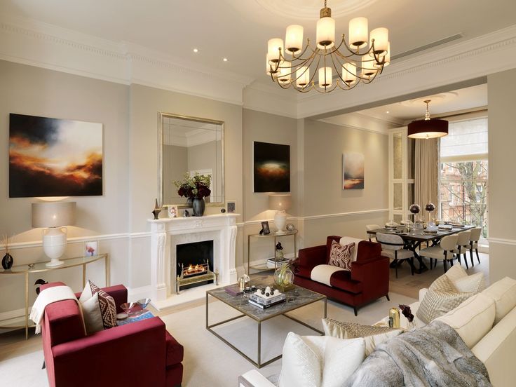 a living room filled with furniture and a fire place in the middle of a room