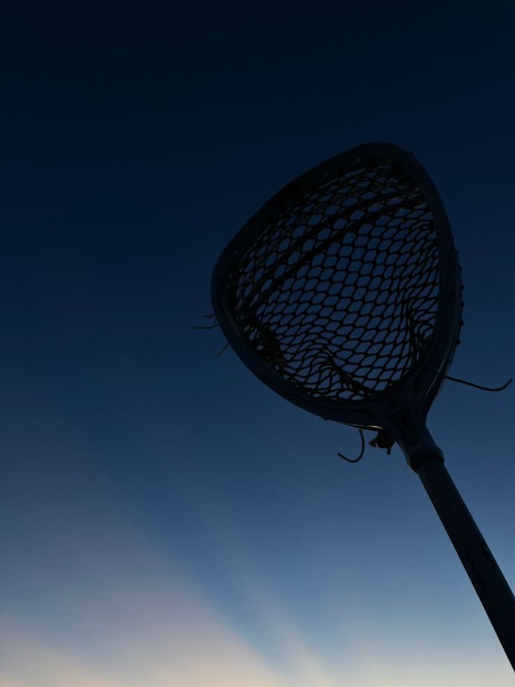 the silhouette of a large metal object against a blue sky