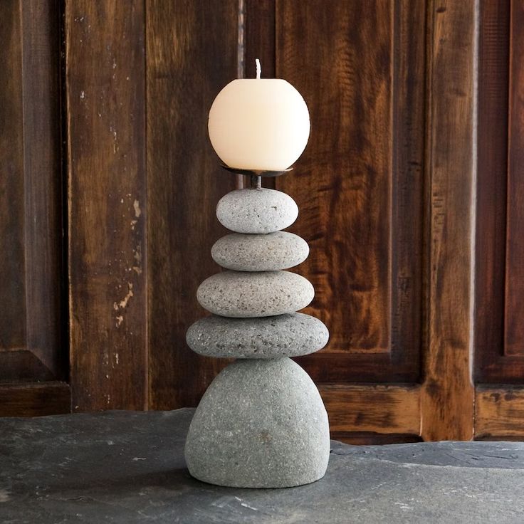 a light that is sitting on top of some rocks in front of a wooden door