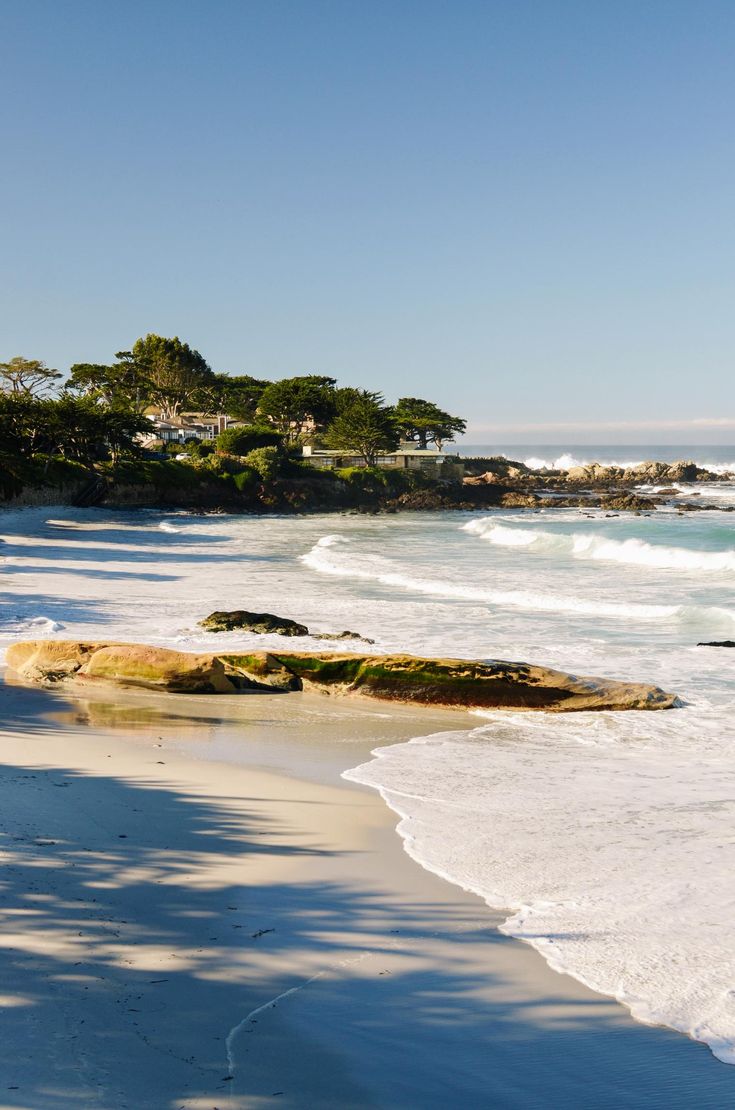 the beach is lined with rocks and water