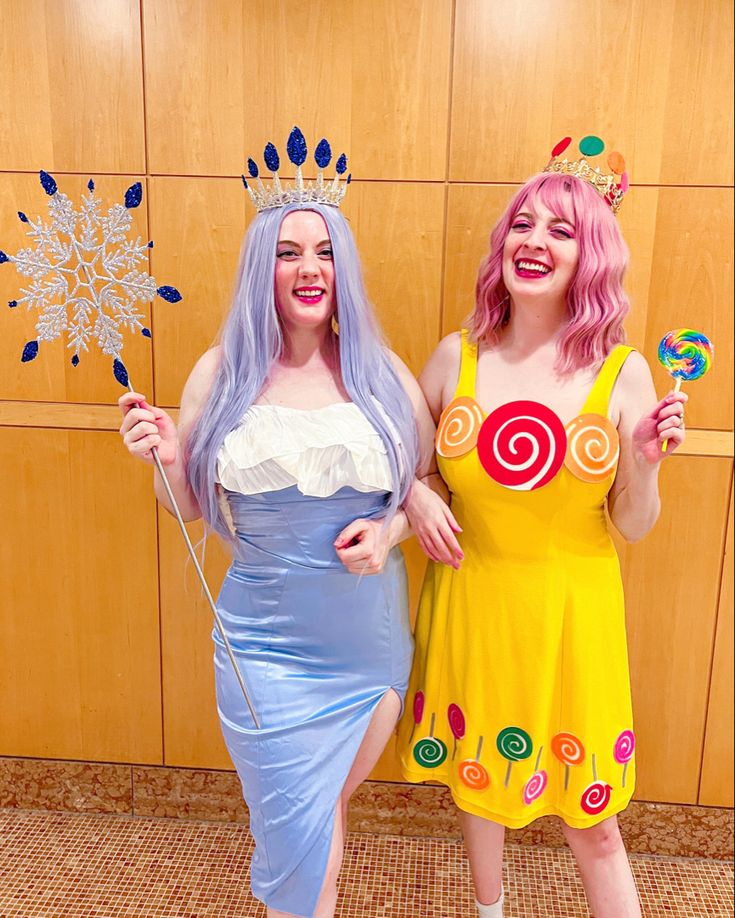 two women dressed in costumes posing for the camera