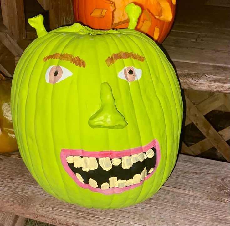 two pumpkins that have been carved to look like faces