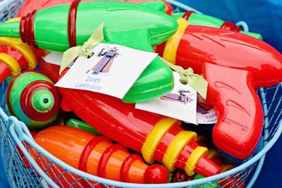 plastic toys in a basket with tags on them