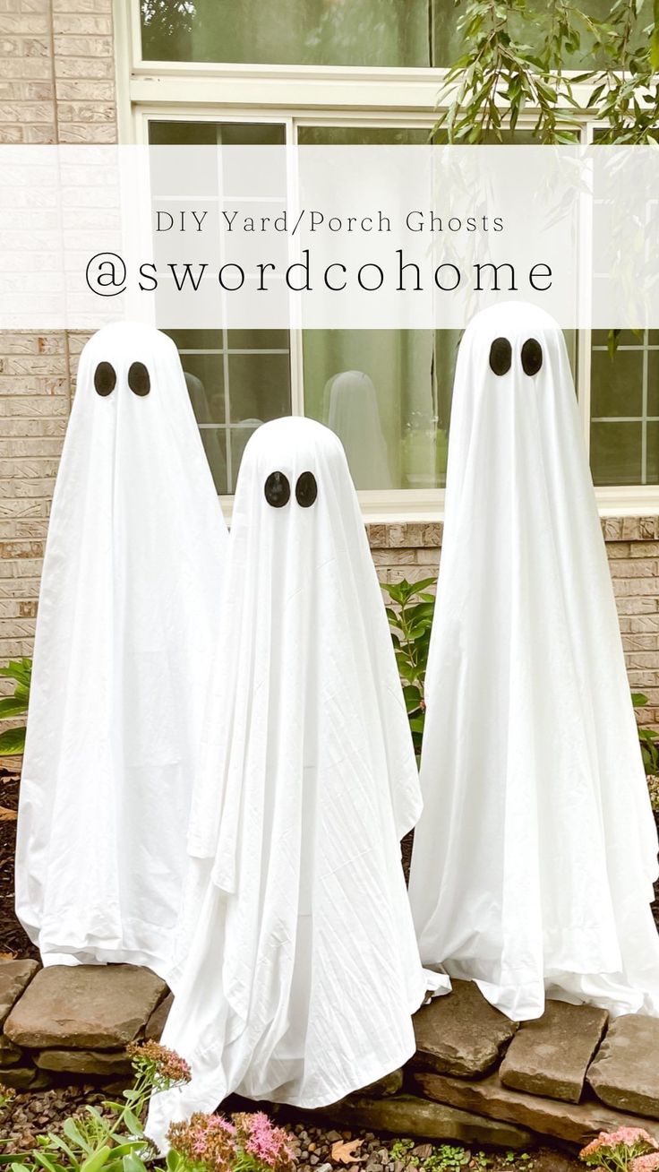 two white ghost statues sitting in front of a window with the words diy yard / porch ghost @ swordcohome