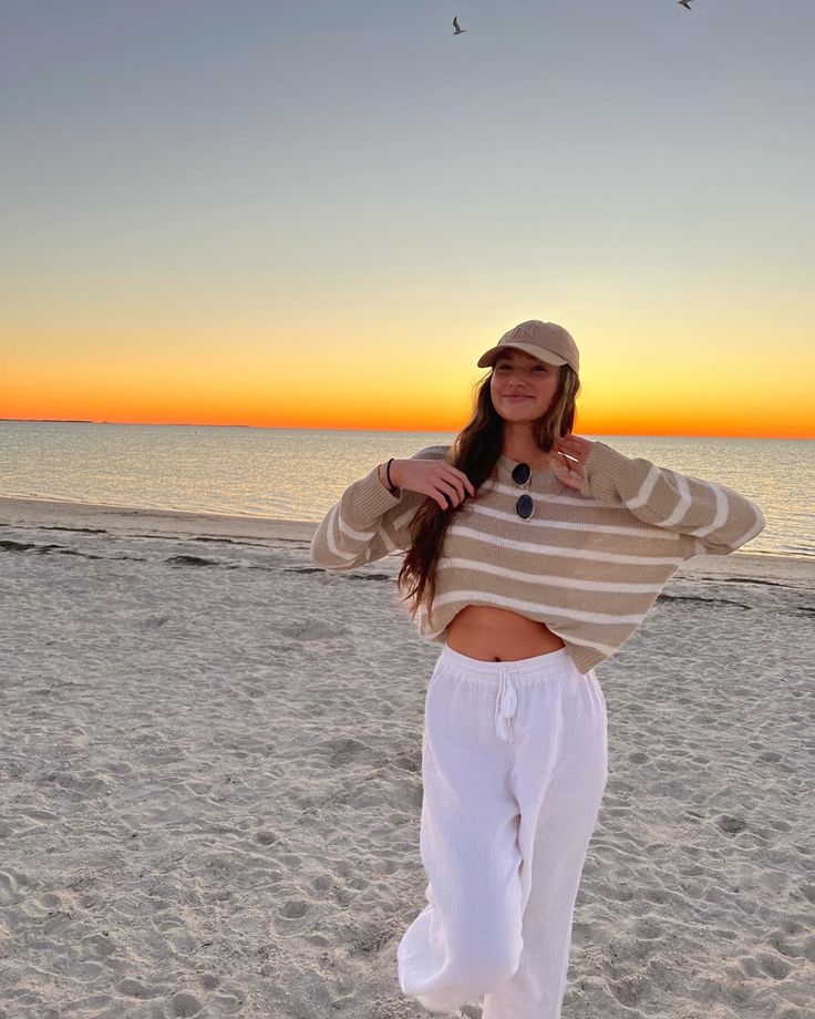 beach outfit, tan striped sweater, white beach pants Cute Beach Outfits Cold Weather, Sunset Outfits Beach Comfy, Legging Beach Outfit, Comfy Beach Outfit Winter, Covered Beach Outfit, 60 Degree Beach Outfit, Comfy Beach Outfit Cold, Cute Beach Winter Outfits, Chilly Beach Day Outfit Casual