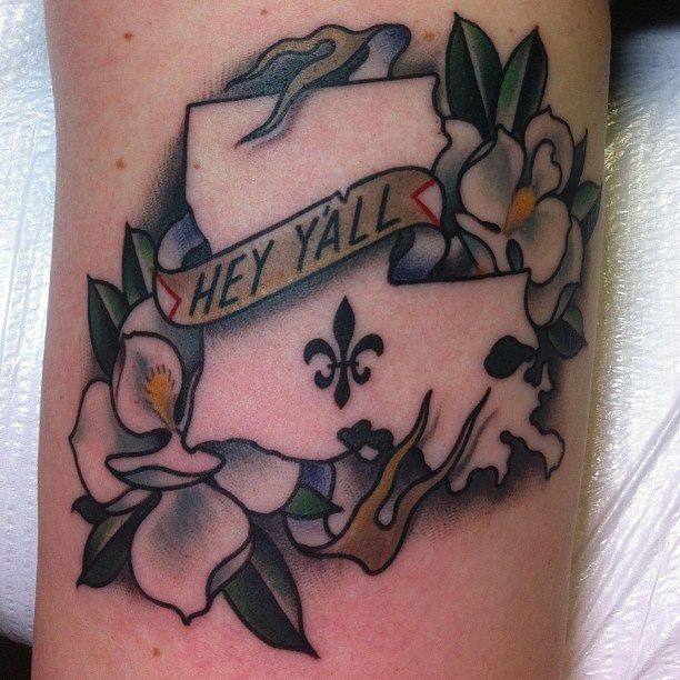 a tattoo with flowers and a banner that says hey y'all