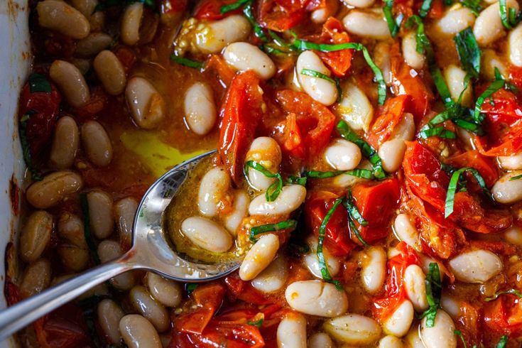 beans and tomatoes are mixed together in a dish