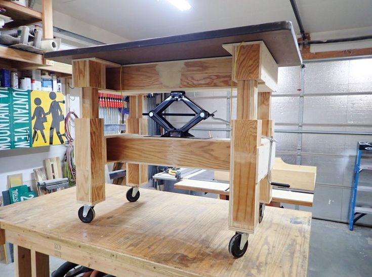 a workbench made out of wood with wheels