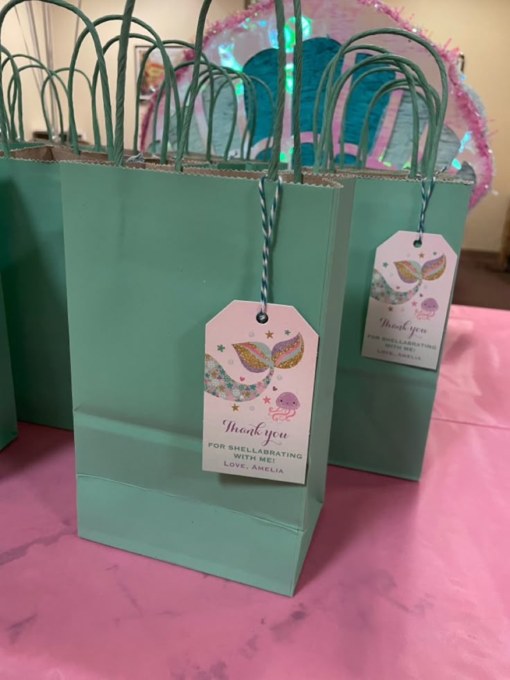 several bags with tags on them sitting on a table in front of some other items