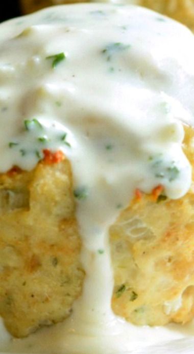 a white plate topped with fried food covered in gravy