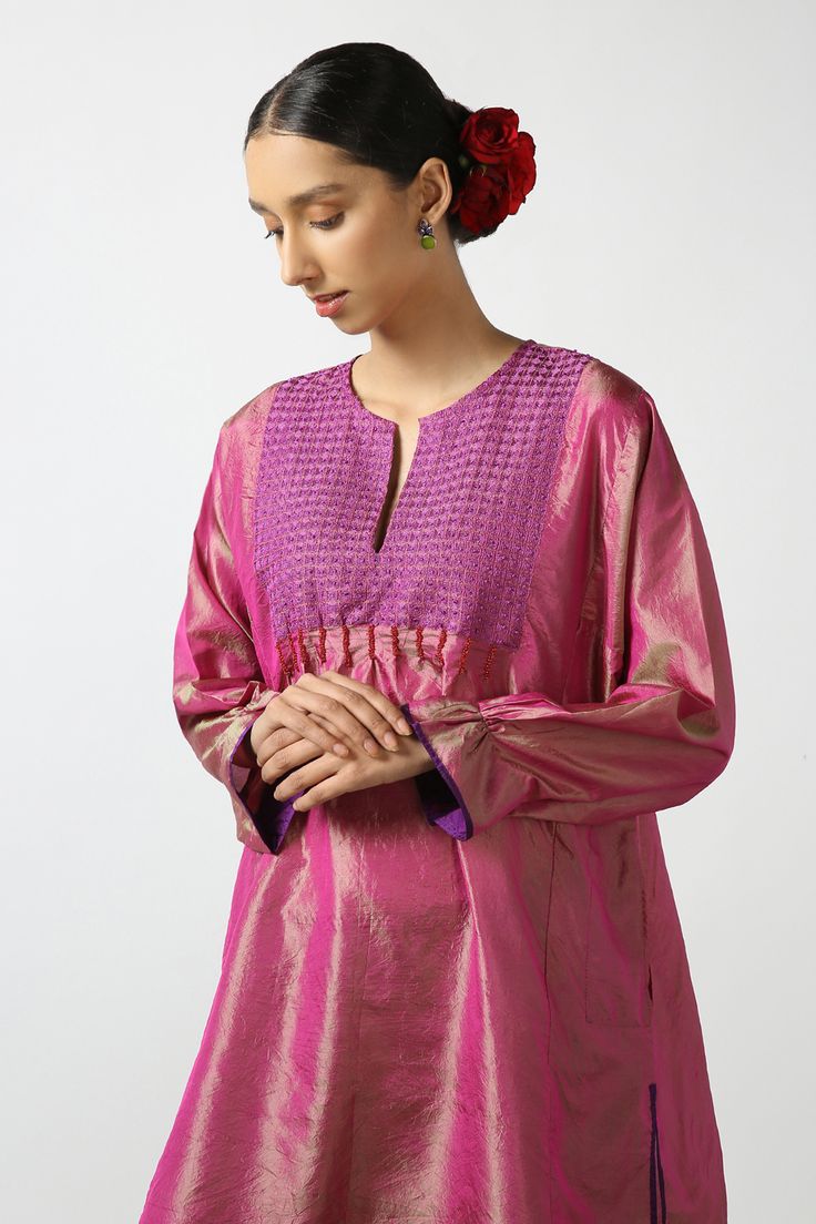 Pink dual toned silk short phiran tunic with contrast thread hand embroidered yoke, bead work highlights and puff sleeves.
Components: 1
Pattern: Hand Embroidered
Type Of Work: Thread and Bead Work
Neckline: Notched Round Neck
Sleeve Type: Puff Sleeves
Fabric: Two Tone Silk
Color: Pink
Other Details: 
Side pockets
Side slits detail
Frill sleeve borders
Note: The pant worn by the model is not for sale
Disclaimer: While the designer strives to recreate every piece as close to what is displayed on Cotton Silk Kurta With Embroidered Sleeves, Long Sleeve Cotton Silk Kurta With Embroidered Sleeves, Cotton Silk Straight Kurta With Yoke, Chanderi Kurta With Embroidered Long Sleeves, Silk Straight Kurta Blouse For Eid, Festive Cotton Silk Tunic Kurta, Silk Blouse For Eid, Eid Silk Straight Kurta Blouse, Elegant Embroidered Blouse For Diwali