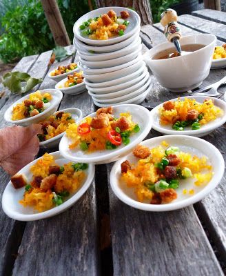 a wooden table topped with lots of plates and bowls filled with different types of food