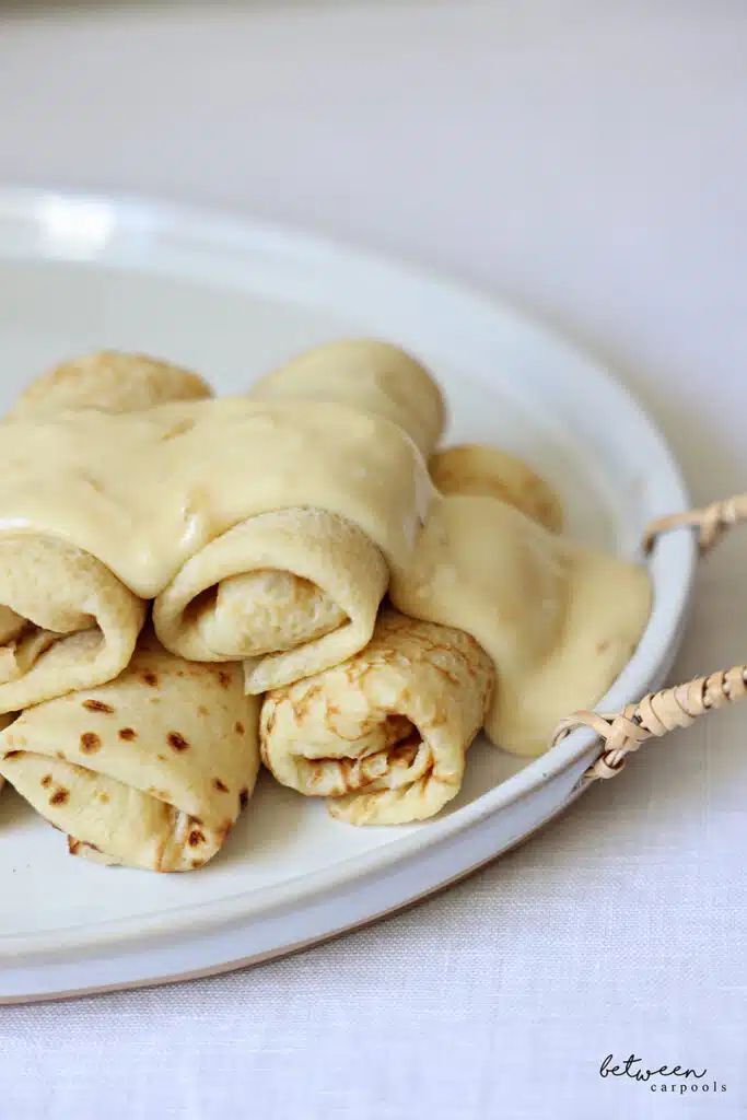 a white plate topped with food covered in sauce