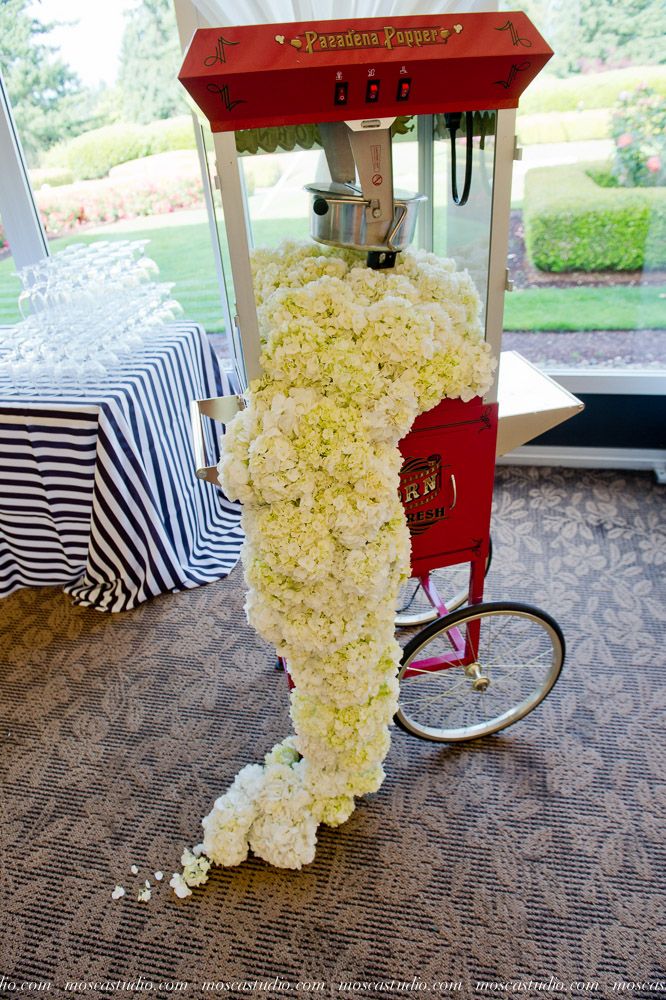 the popcorn machine is covered in white flowers