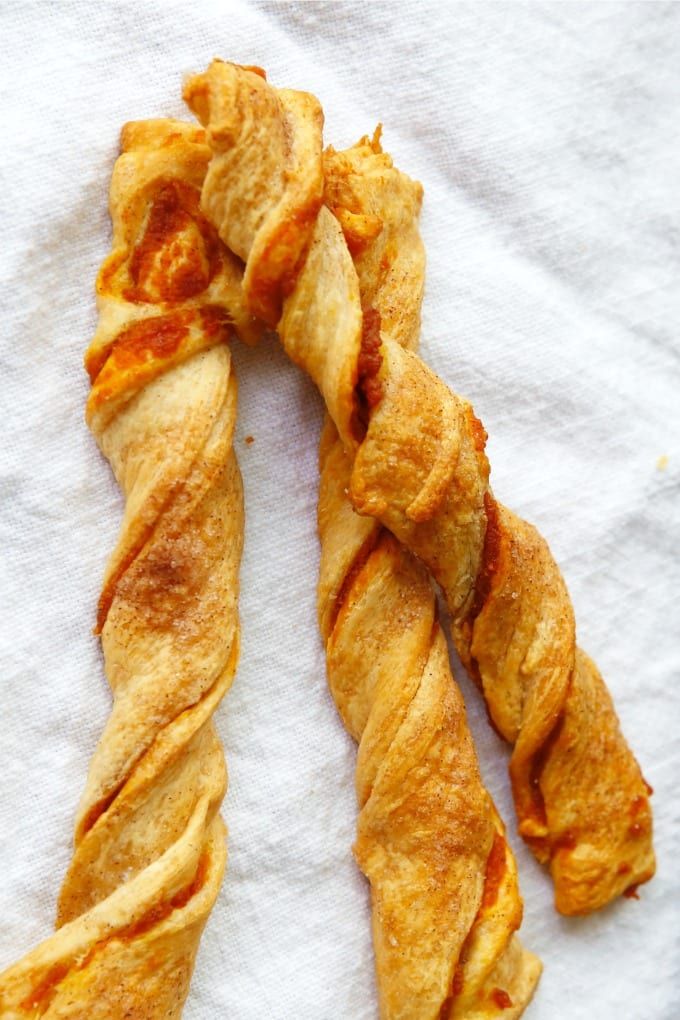 two pieces of bread that are sitting on a towel