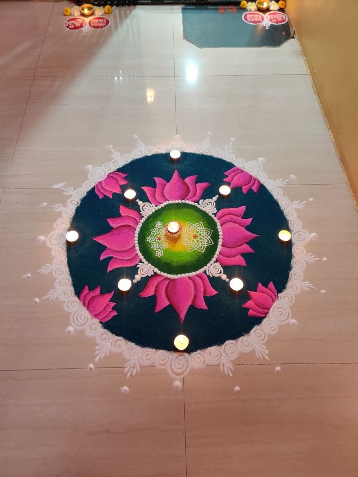 a decorated floor with candles on it and a circular design in the middle that looks like a flower