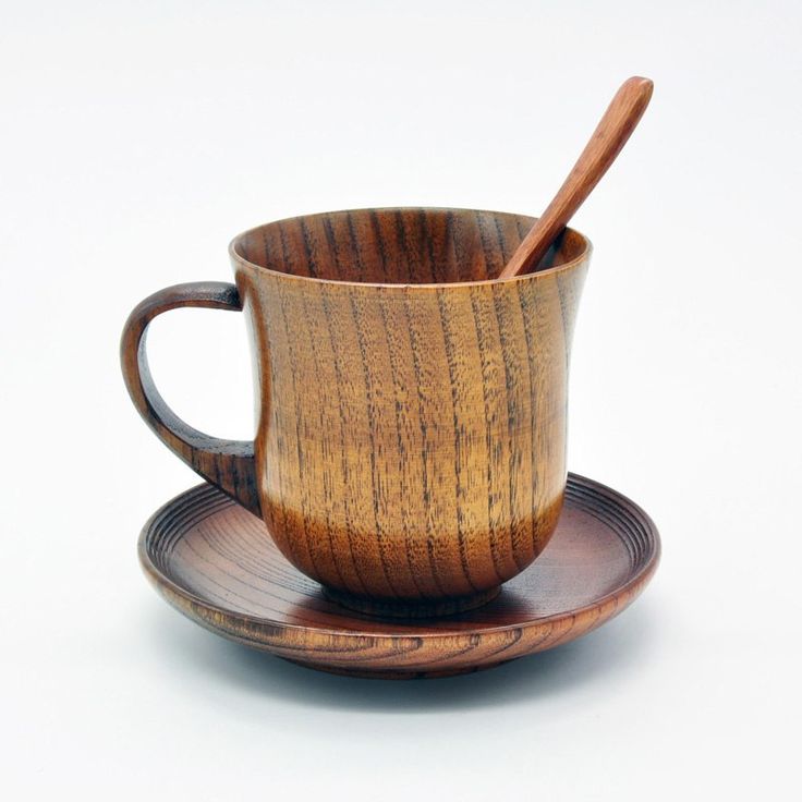 a wooden cup and saucer on a plate