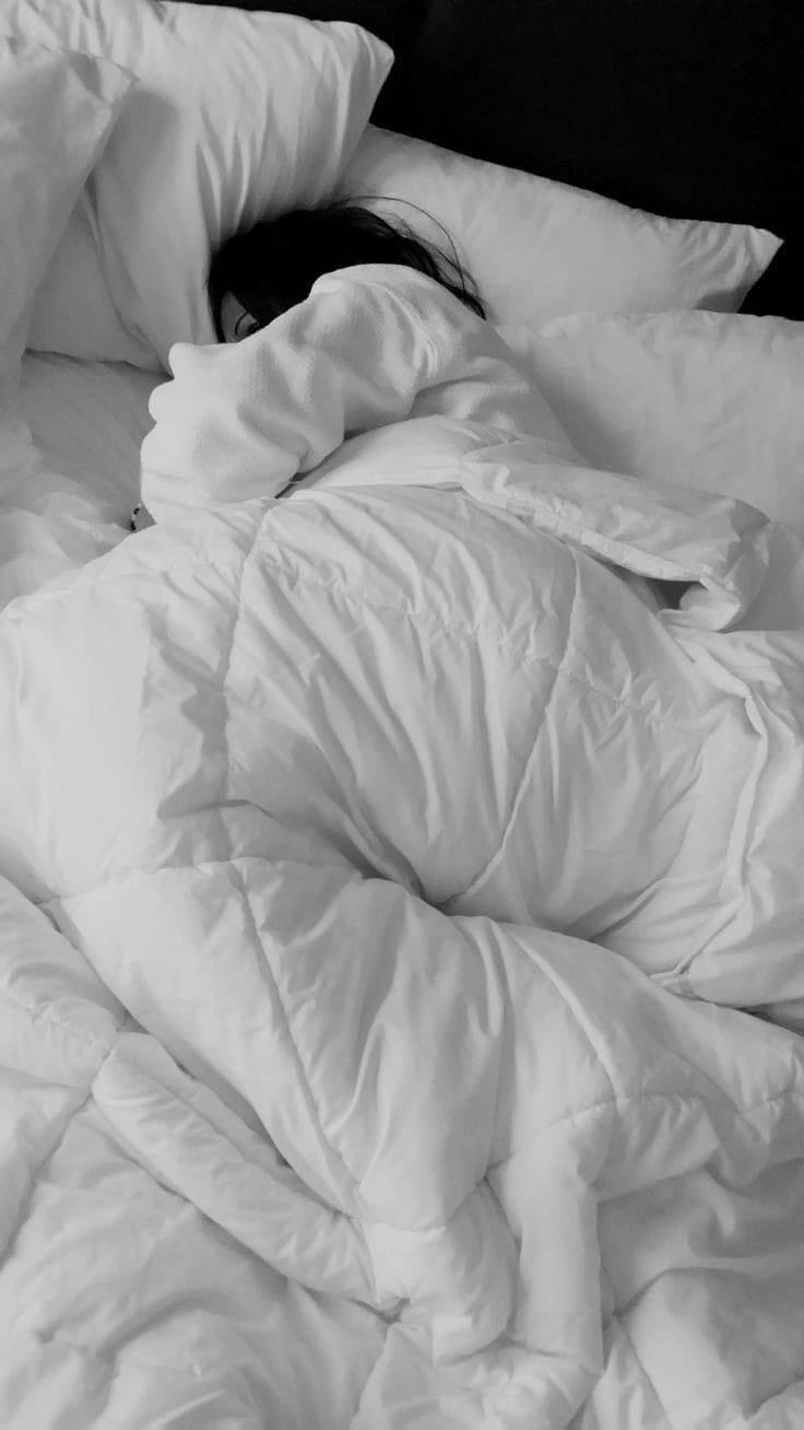 an unmade bed with white sheets and pillows on it's sides is shown in black and white