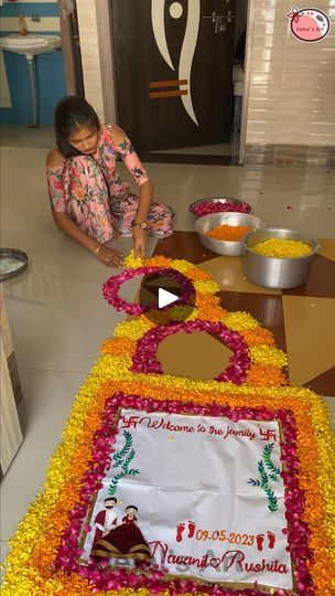 a woman cutting a large cake on top of a table covered in yellow and red flowers