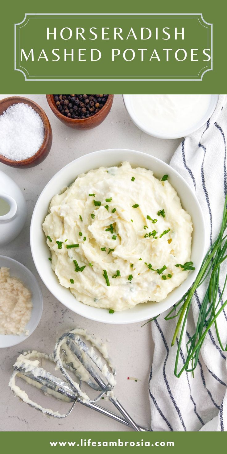 mashed potatoes in a white bowl with herbs and other ingredients around it on a table