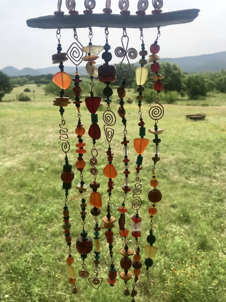 a wind chime hanging in the middle of a field