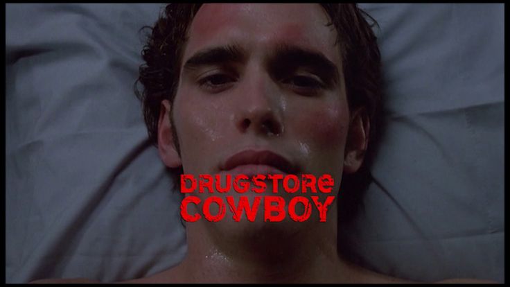 a man laying in bed with the words drugstorie cowboy over his face and mouth