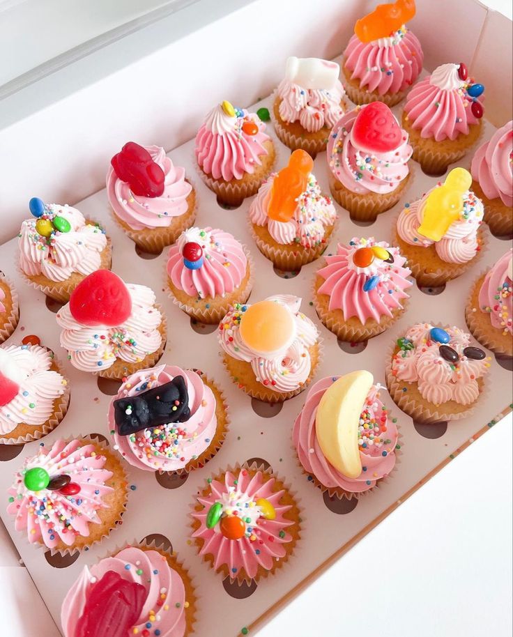 a box filled with lots of cupcakes covered in frosting