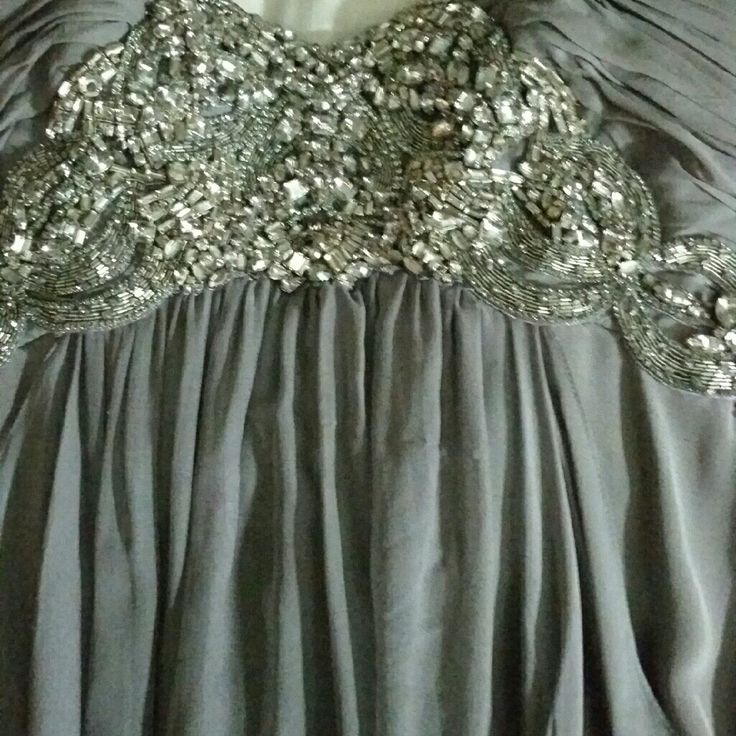 Grey Gown With Silver Stone Detail Perfect For A Wedding Or A Dressy Function Gray Wedding Dresses For Prom Season, Gray Wedding Dress With Sweep Train, Dressy Silk Evening Dress For Wedding, Silver Evening Dress With Fitted Bodice, Silver Fitted Bodice Evening Dress, Gray Evening Dress With Sweep Train For Wedding, Floor-length Gray Dresses For Wedding, Gray Floor-length Wedding Dresses, Embellished Dressy Wedding Dress