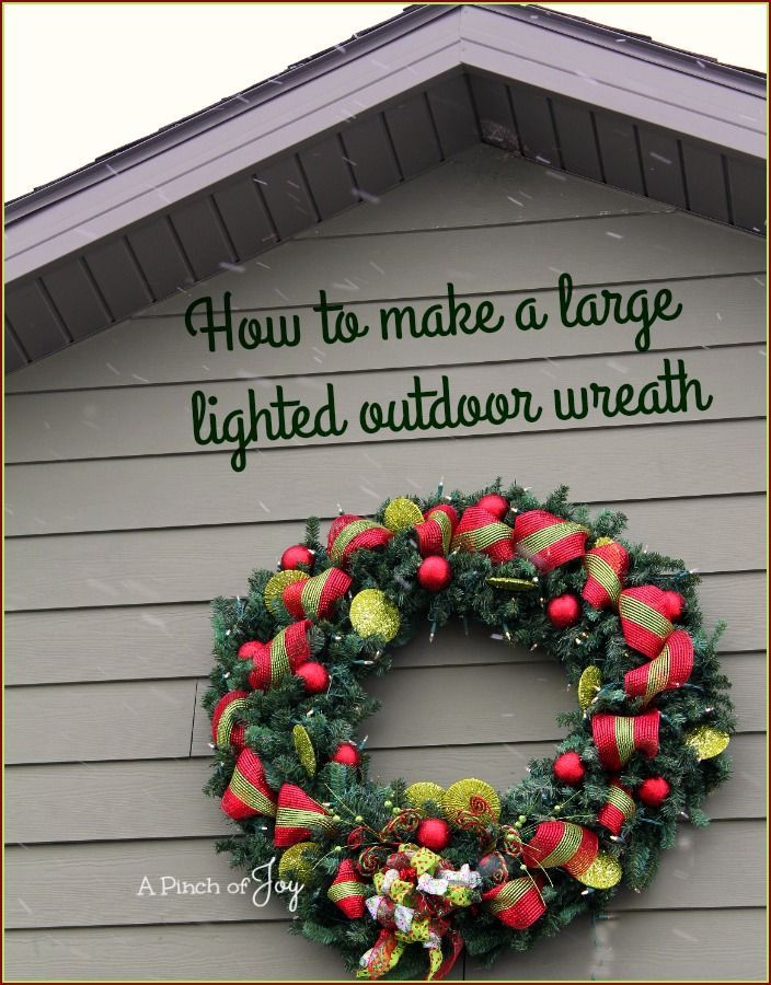 a christmas wreath on the side of a house with a quote about how to make a large lighted outdoor wreath