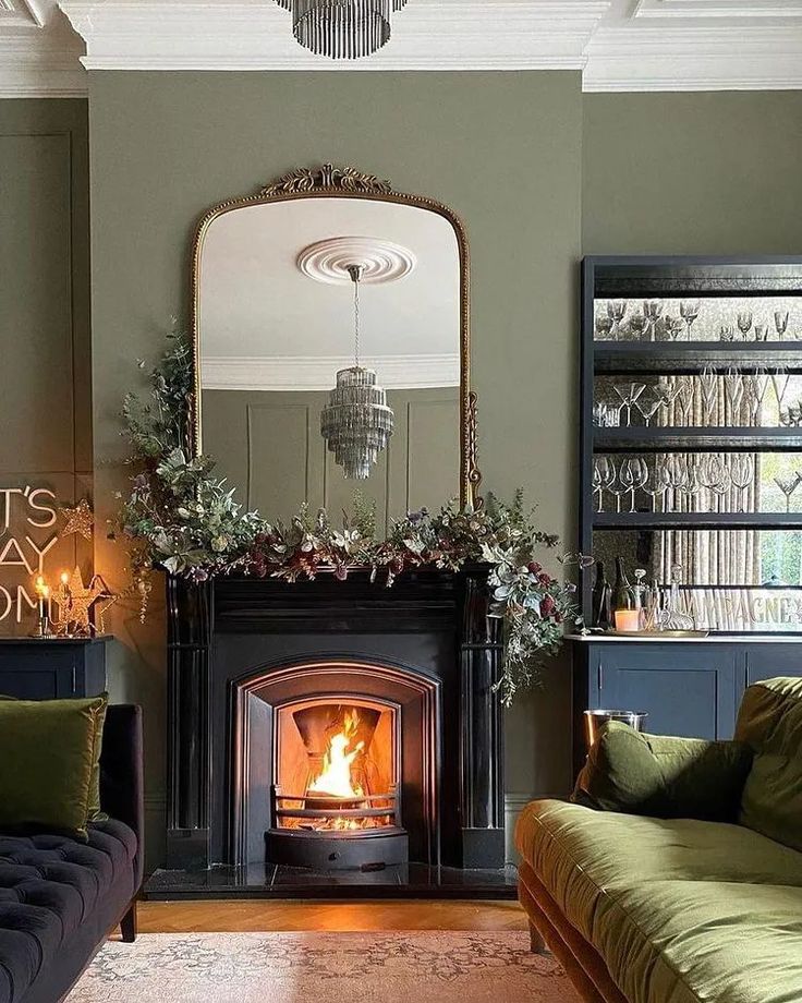 a living room filled with furniture and a fire place next to a mirror on the wall